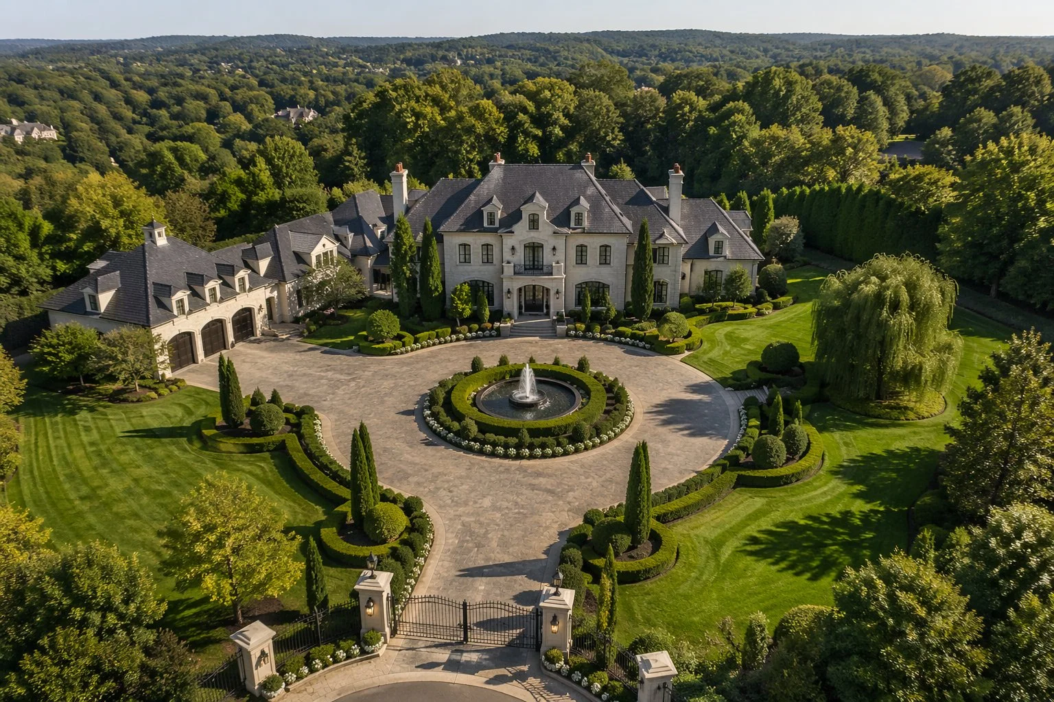 Luxury estate landscaping with circular fountain driveway and manicured grounds by GreenCraft Landscaping